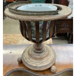 A 19th century mahogany jardiniere stand of urn shape with slatted sides a turned column and