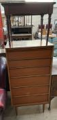 A mid 20th century teak chest with six graduated drawers on tapering legs together with a