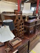 A wine rack together with three table lamps and a table top display cabinet