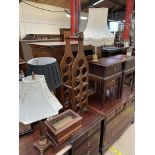 A wine rack together with three table lamps and a table top display cabinet