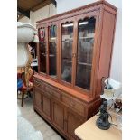 A modern Chinese hardwood wall unit, with two pairs of glazed doors,
