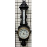 An oak framed aneroid barometer, with a leaf carved cresting, mercury thermometer,