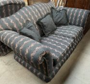 A modern two seater settee decorated with bands of flowers and leaves together with a matching