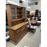 An Ercol dining suite comprising an extending dining table,