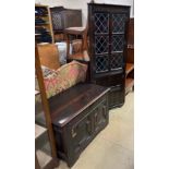 An 18th century oak coffer with a geometric front together with a standing corner cupboard