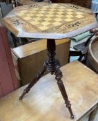 A Victorian games table with an octagonal top inset with a chess board on a reeded column and three