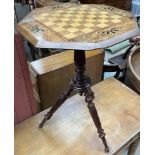 A Victorian games table with an octagonal top inset with a chess board on a reeded column and three