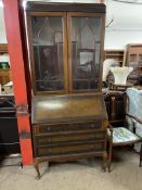 A 20th century mahogany bureau bookcase, the blind fret cornice above a pair of glazed doors,