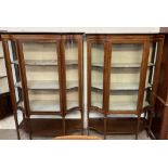 A matched pair of Edwardian mahogany display cabinets, with moulded cornice, glass doors,