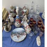 A Lladro figure of a seated boy together with glass decanters, drinking glasses, collectors plates,