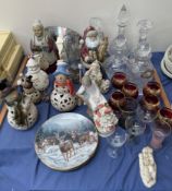 A Lladro figure of a seated boy together with glass decanters, drinking glasses, collectors plates,