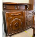 A 20th century oak dining suite comprising a sideboard,