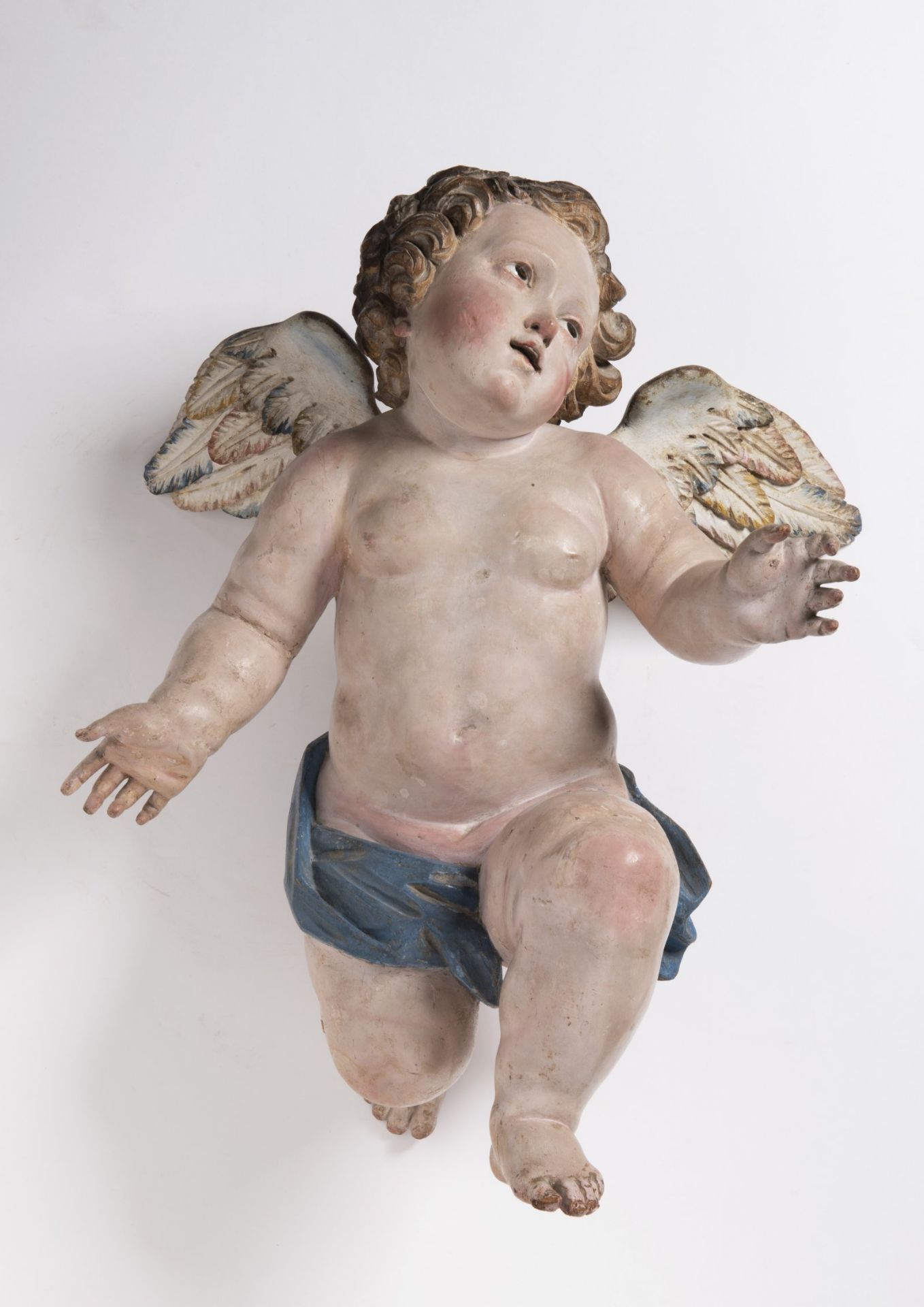 A FLYING PUTTO 18th century Italy Naples Polychrome wood, glass 43 cm Wood carving of a flying putto