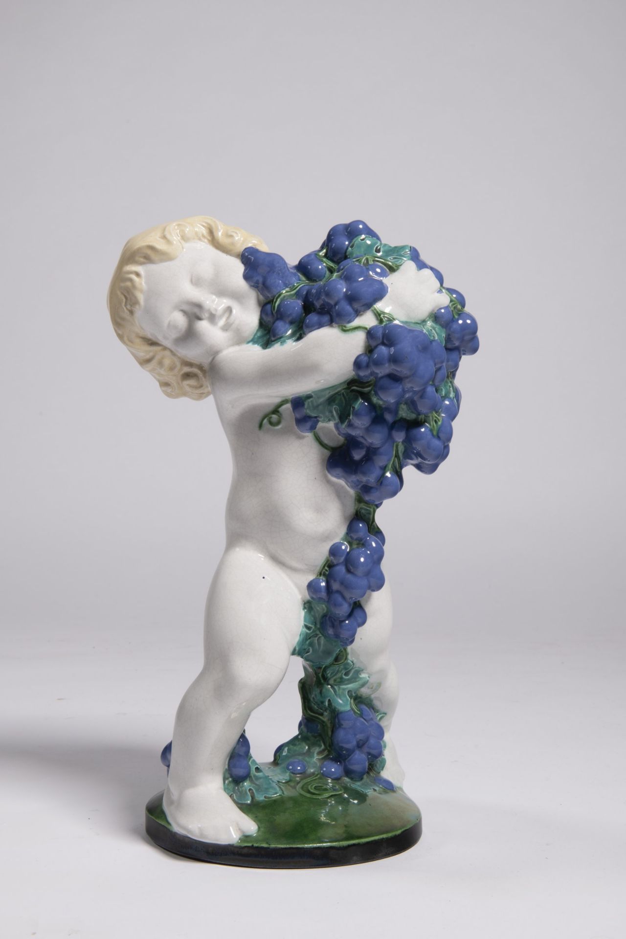 MICHAEL POWOLNY 1871 - 1954: PUTTO WITH BLUE GRAPES - AUTUMN 1907 Austria Glazed pottery 38 cm Art