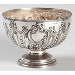 A VICTORIAN SILVER ROSE BOWL, CHESTER 1899, G.N.R.H., reeded rim, the bowl elaborately embossed with