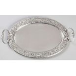 A SILVER TWIN-HANDLED TRAY, BIRMINGHAM DATES AND MAKER'S MARKS INDECIPHERABLE, fold-over rim, the