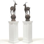 Two Metal Antilope Sculptures on White Pedestals