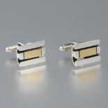 A Pair of Cartier Sterling Silver and 18k Gold Cufflinks