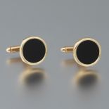 A Pair of Gold and Onyx Cufflinks
