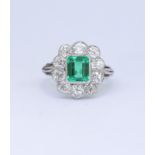 IMPORTANT 1.55 ct. COLOMBIAN EMERALD AND DIAMOND CLUSTER RING