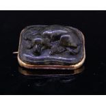 AN ANTIQUE CARVED JADE BROOCH