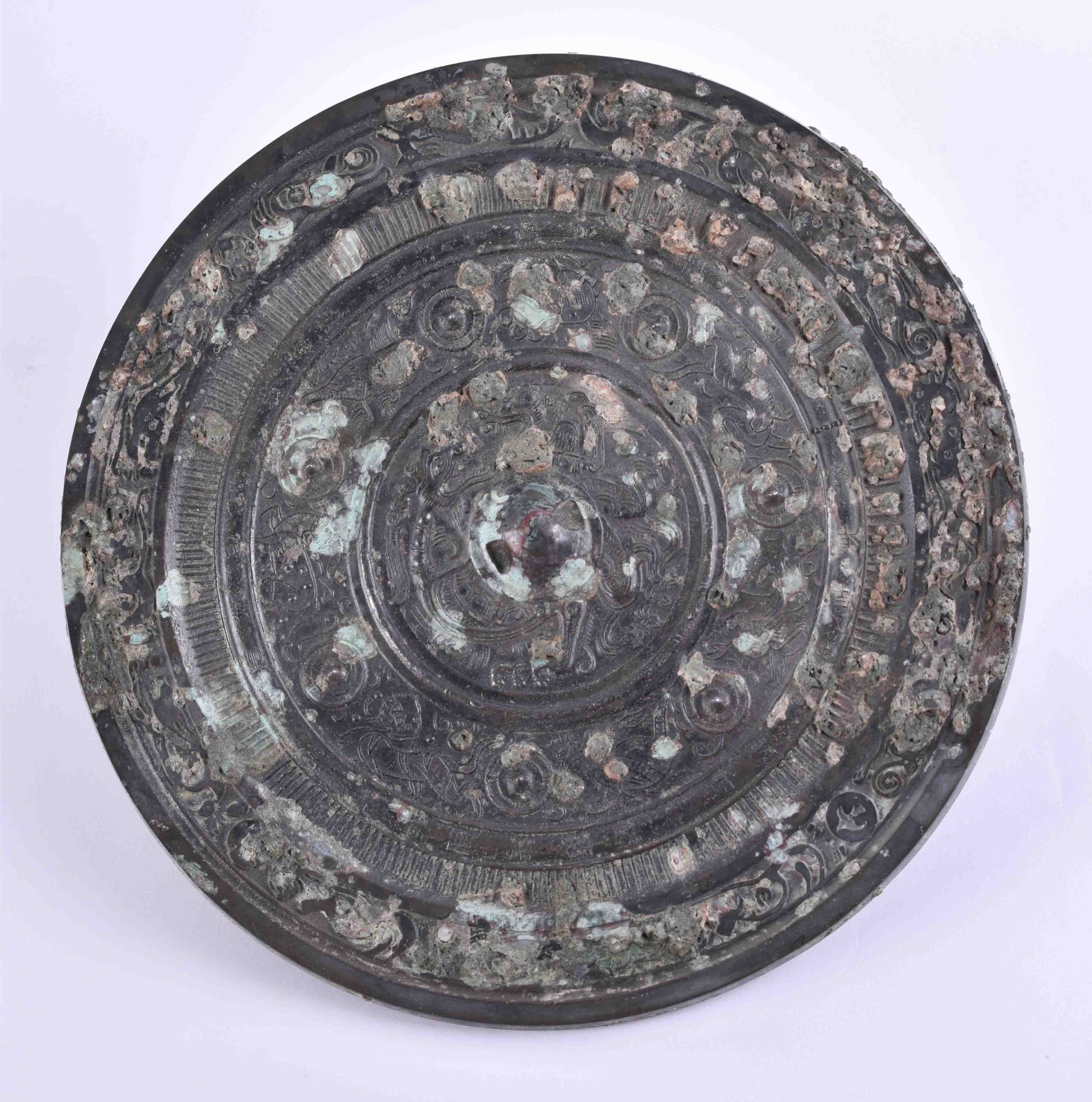 Bronze mirror China probably Tang dynastyon the front side with relief decor, Ø 20.5 cm, weight