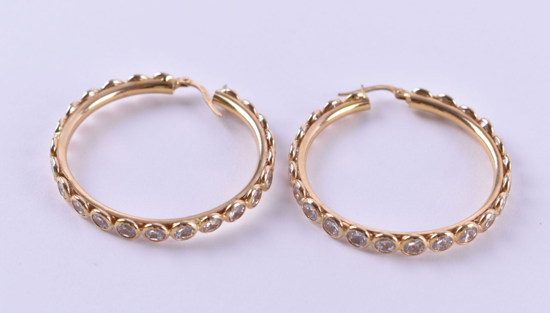 A pair of creoles585 yellow gold, gold proofed, a pair of creoles each Ø 4 cm with zirconia, 10.3