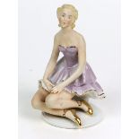BallerinaPorzellan mit koralleroter Manufakturmarke, Ballerina im kurzen Kleid auf rundem Sockel
