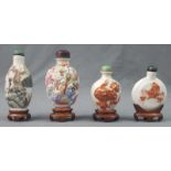 4 snuff bottles. China / Japan, old. Each with a wooden base.