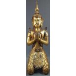 Kneeling Buddha. Carved wood. Gold colored with glass highlights.