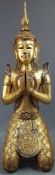 Kneeling Buddha. Carved wood. Gold colored with glass highlights.