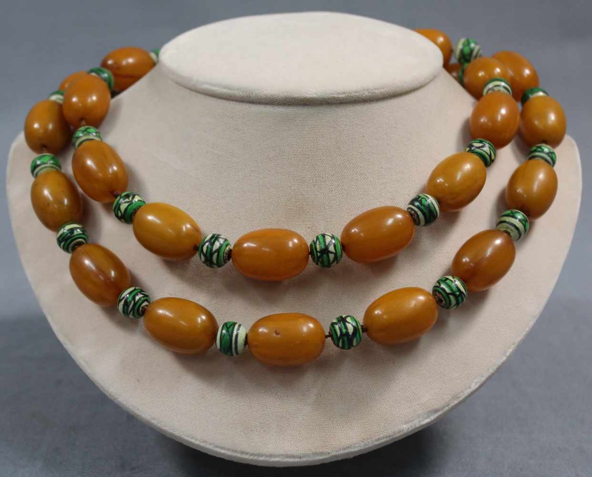 Amber necklace with additional green balls.