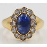 Yellow gold 750 ring with a Sapphire cabochon framed by 12 diamonds.