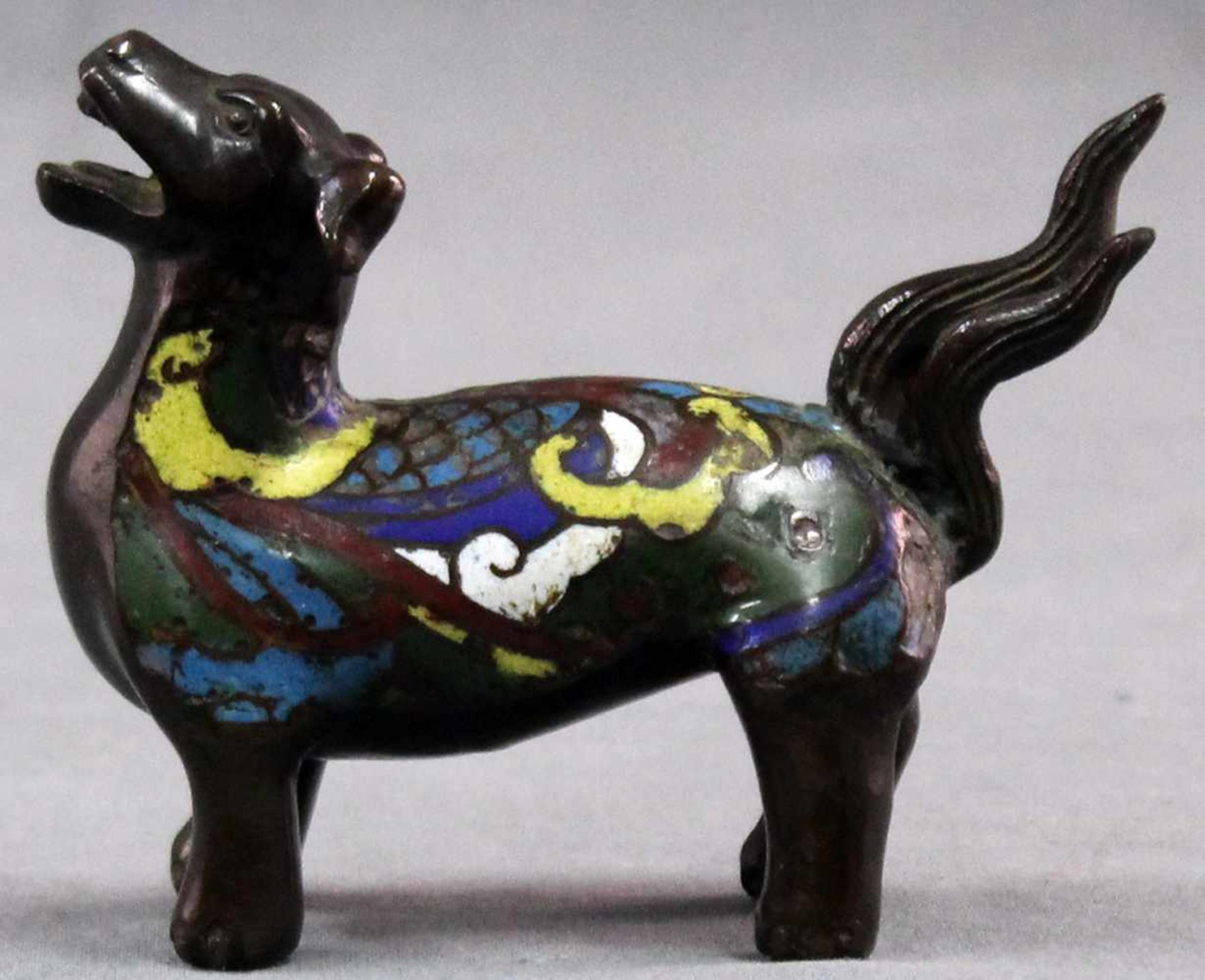 Bronze dog with cloisonne. Proably China old. 10 cm long.