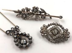 Two brooches and a necklace. Diamonds, gold and silver.A total of approximately 3 carats of diamonds