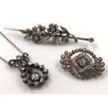 Two brooches and a necklace. Diamonds, gold and silver.A total of approximately 3 carats of diamonds