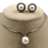 White gold 585. Necklace and 2 ear studs. Pearls probably Mabe. Diamonds.The diamonds together total