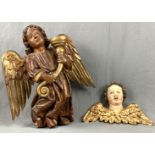 2 sculptures. Angels as candle holder and a putto,Up to 52 cm x 49 cm. Carved wood with polychrome