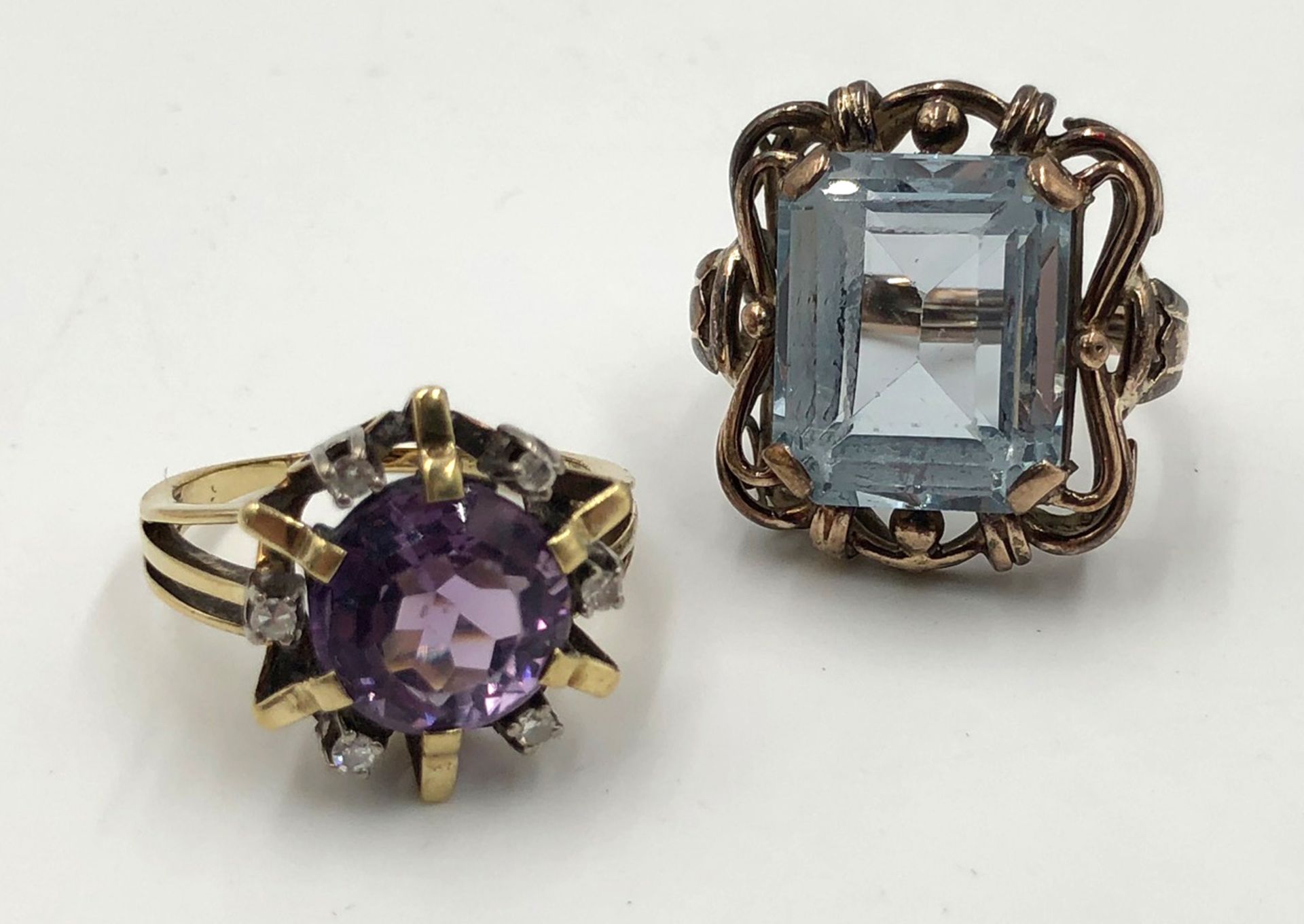 2 rings yellow gold 585.One with amethyst and 6 small diamonds. The other ring with a light blue