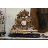 A 19th century French gilt spelter mantel clock, half-hour striking on a bell, with cow and