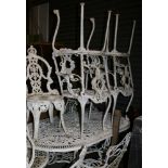 An aluminium garden table of rectangular oval form with pierced decoration and six armchairs