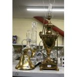 A brass ship's bell, a porthole ship clock and a cast brass vase lamp base. [s13] FOR DETAILS OF