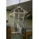 A fine quality silver-plated and bevelled glass tapering hexagonal lantern with 'candle' lights,