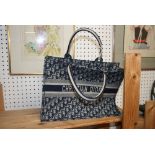 A woven tote bag with Christian Dior monogram design [upstairs wooden shelves] FOR DETAILS OF ONLINE