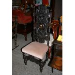 An early 19th century carved oak dining chair, the ornately worked back with scrolls and acanthus