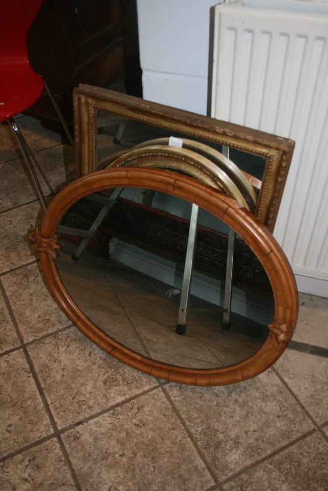 Two mirrors in gilt moulded frames, one rectangular the other oval and a Victorian oval mirror in