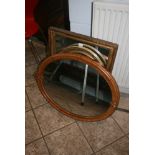Two mirrors in gilt moulded frames, one rectangular the other oval and a Victorian oval mirror in
