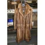 A lady's light reddish brown mink fur full-length coat with half-belt and buttoned cuffs [upstairs