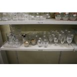 A large selection of various cut-glass drinking glasses, together with a dressing table set,