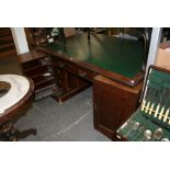 An unusual Victorian mahogany knee-hole desk, the large rectangular top inset with tooled green